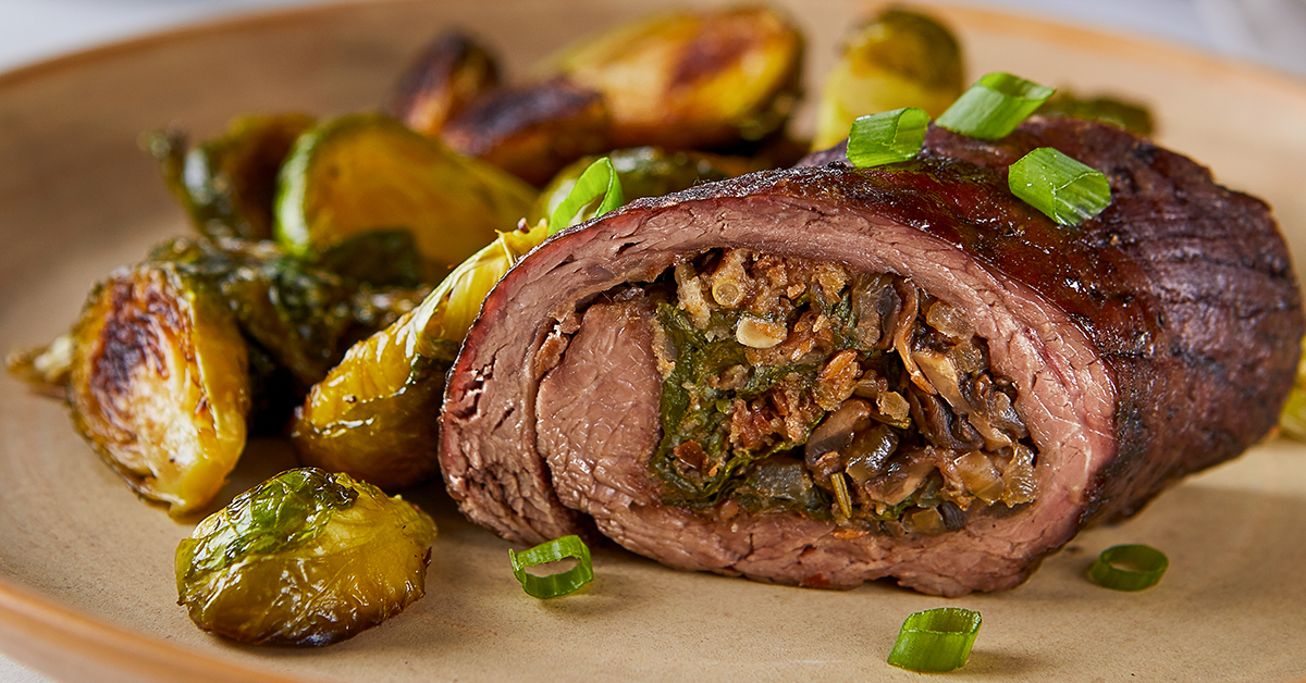 Flank steak stuffed with spinach, mushrooms and onions with a side of Brussels sprouts.