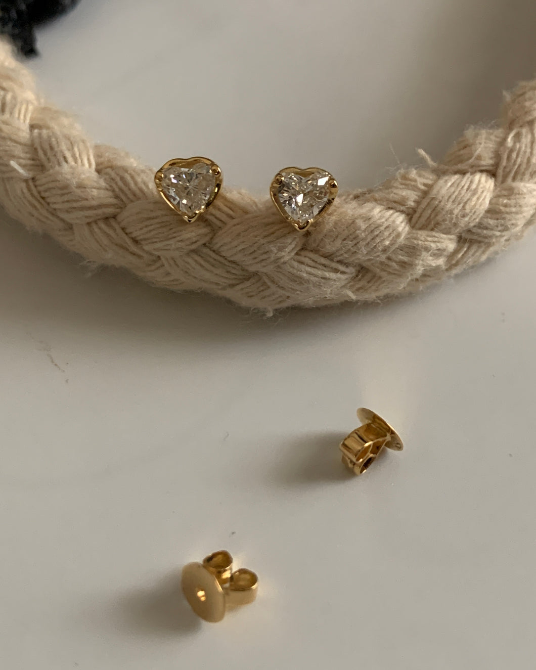 Heart shaped diamond stud earrings set in yellow gold.