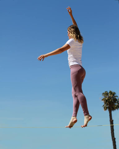 Olga Henry standing on slack line.