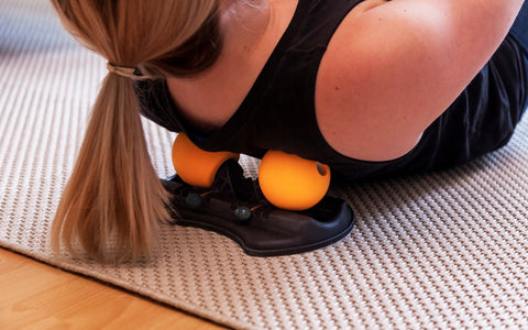 Woman using the HighBaller Adjustable Massage Ball on her neck