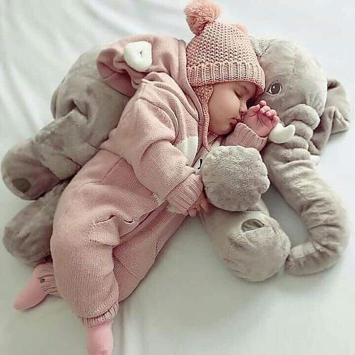 baby with elephant pillow