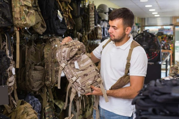 A customer examines a tactical bag