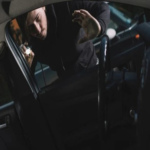 Man looking into a vehicle 