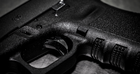 A black and white focus image of a gun