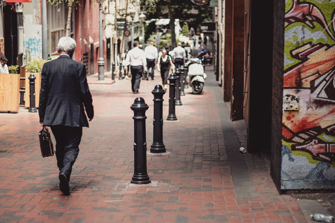 businessman walking on brick street