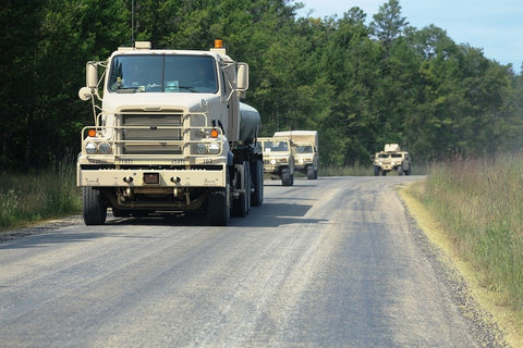 a line of armored trucks on a road