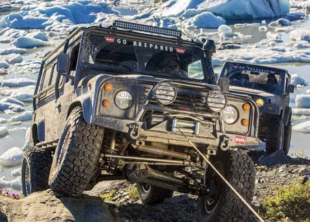 4x4 vehicle being winched up a hill