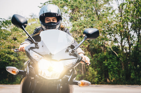 Person on Motorcycle with Helmet