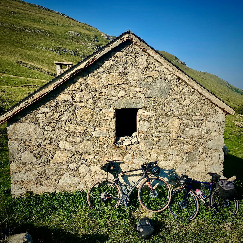 Bikes leaning against the wall of a mountain refuge on a bikepacking trip