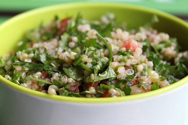 Quinoa tabouleh in a green bowl