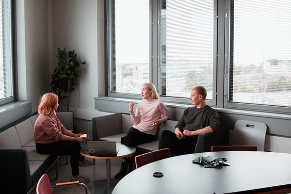 two women and a man in a meeting