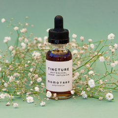 Tincture Bottle Surrounded by Tiny White Flowers