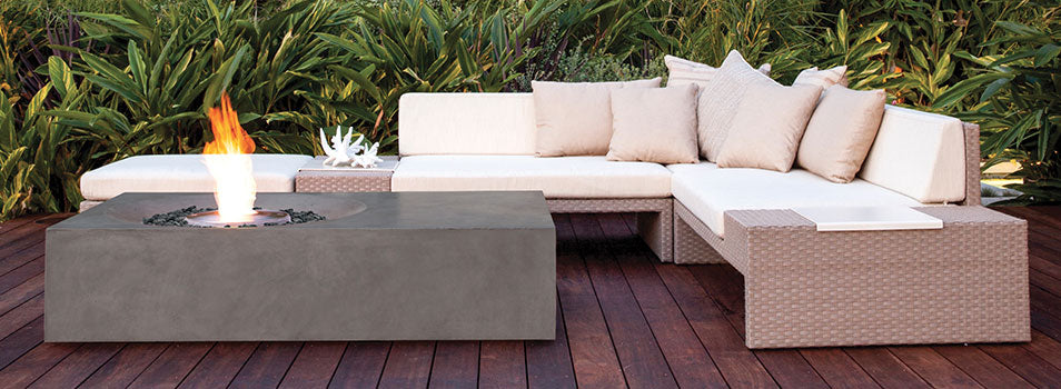 Gray firetable from Ecosmart Fire in use with white cushioned patio furniture on wooden deck