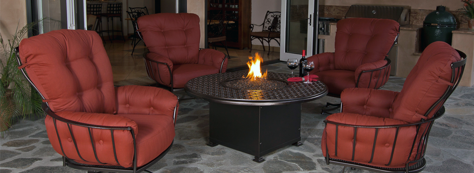 Monterra patio lounge chairs in red color near a fire pit from OW Lee