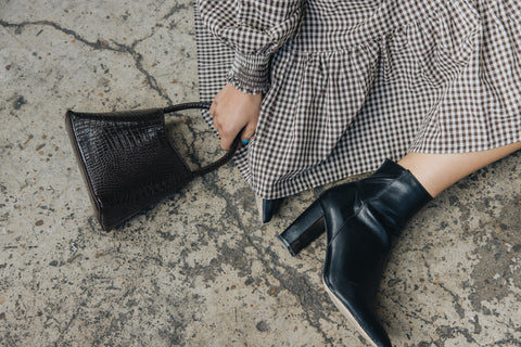 Image of bag, dress and heeled boot