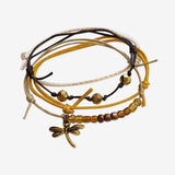 Dragonfly Bracelet 4 piece set is adjustable with stackable bracelets in mustard yellow and brown cords, a gold dragonfly charm and golden beads. Fun styled and stacked bracelets. Stack these corded bracelets. Created by O Yeah Gifts!