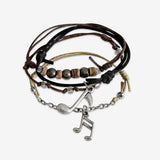 Music Note Bracelet 4 piece set is adjustable with stackable bracelets in black, brown and beige cords, 2 silver music note charms and coconut beads. Eco friendly style stacked bracelets. Stack these corded bracelets. Created by O Yeah Gifts!