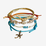Stackable Starfish Bracelet 4 piece set. Blue waves and orange cord bracelets are adjustable. Displayed with a gold starfish charm and shell beads. Stack bracelets are handmade. Created by O Yeah Gifts!