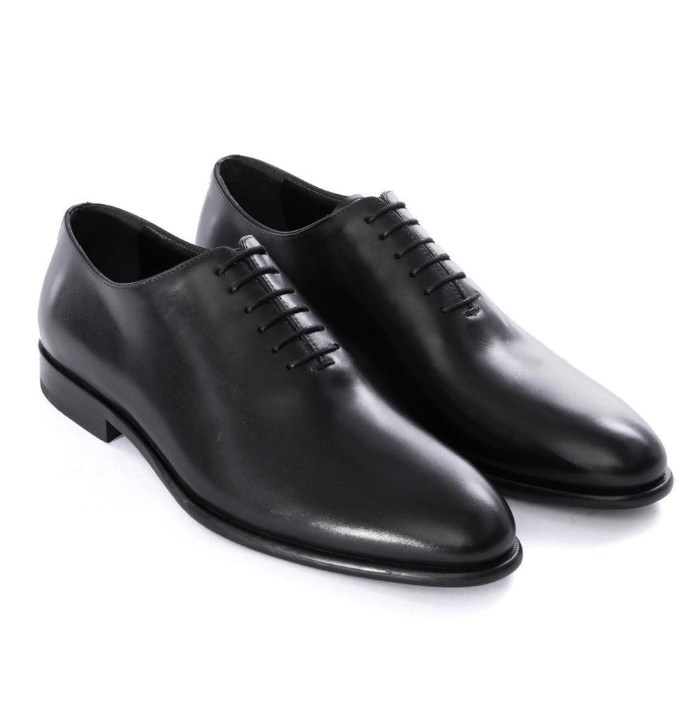 black wholecut shoes