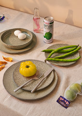 table setting with organic shaped plates and vegetables