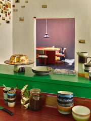 open kitchen with green countertop and retro style ceramics