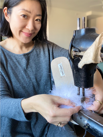 footwear designer making sandals with feather