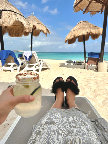 feather flip flops by the beach