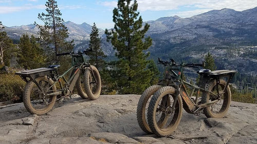 Two Rungu Dualie Fat Tire Electric Bikes on a mountain