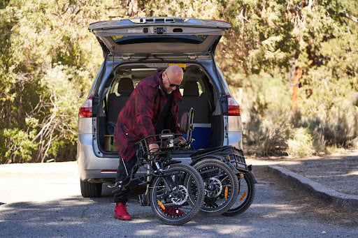 Man folding etrike to fit in car