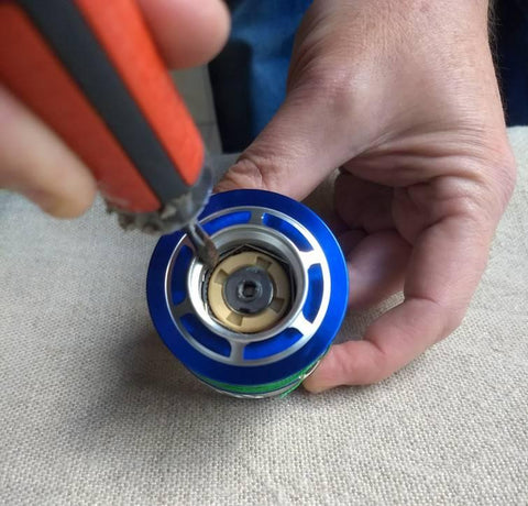Removing the clip to access the drag washers