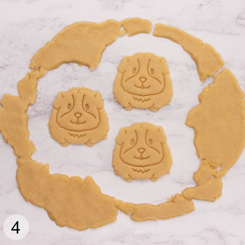 Remove the negatives and transfer the cookie dough cut outs to a baking tray