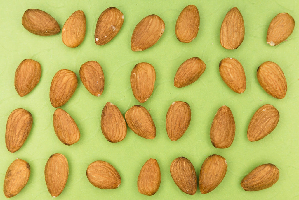 almonds on green background