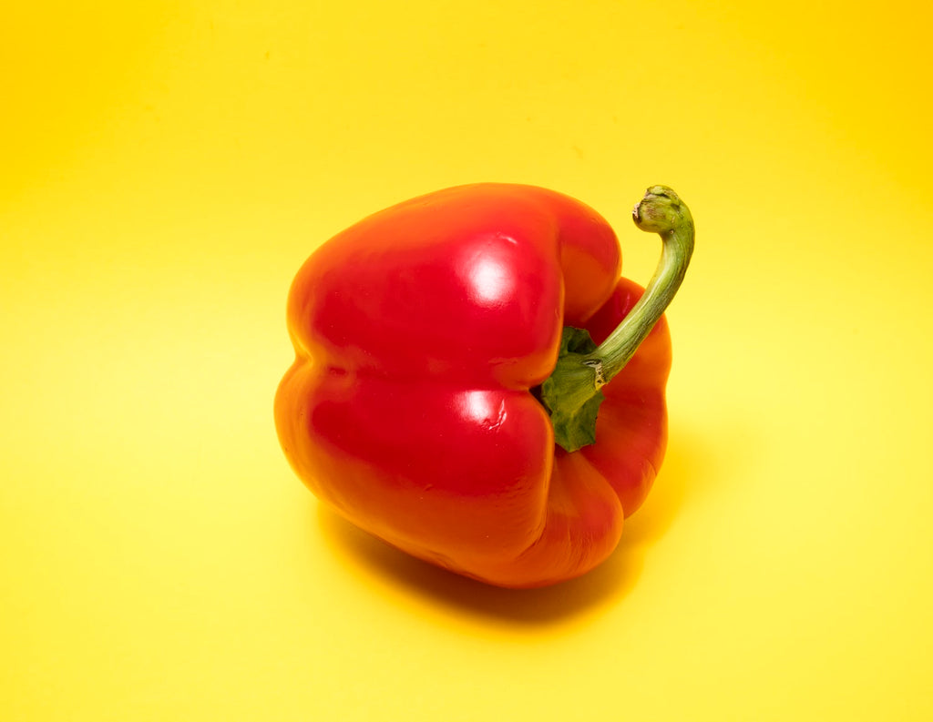 red bell pepper yellow background
