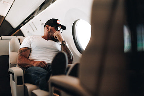 Andy Frisella sitting on an airplane