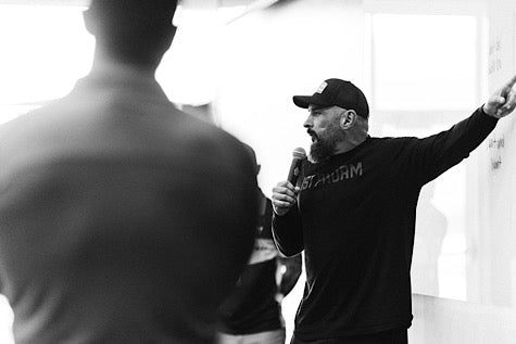 Andy Frisella pointing at a white board