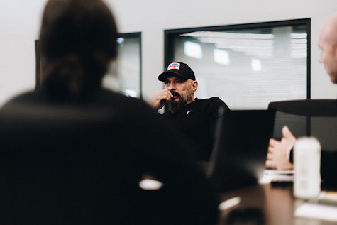 Andy Frisella sitting at a table