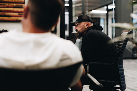 Andy Frisella sitting at a table