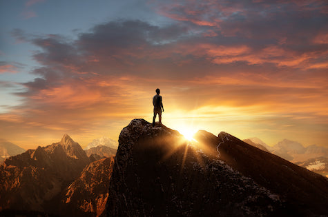 Man at top of mountain