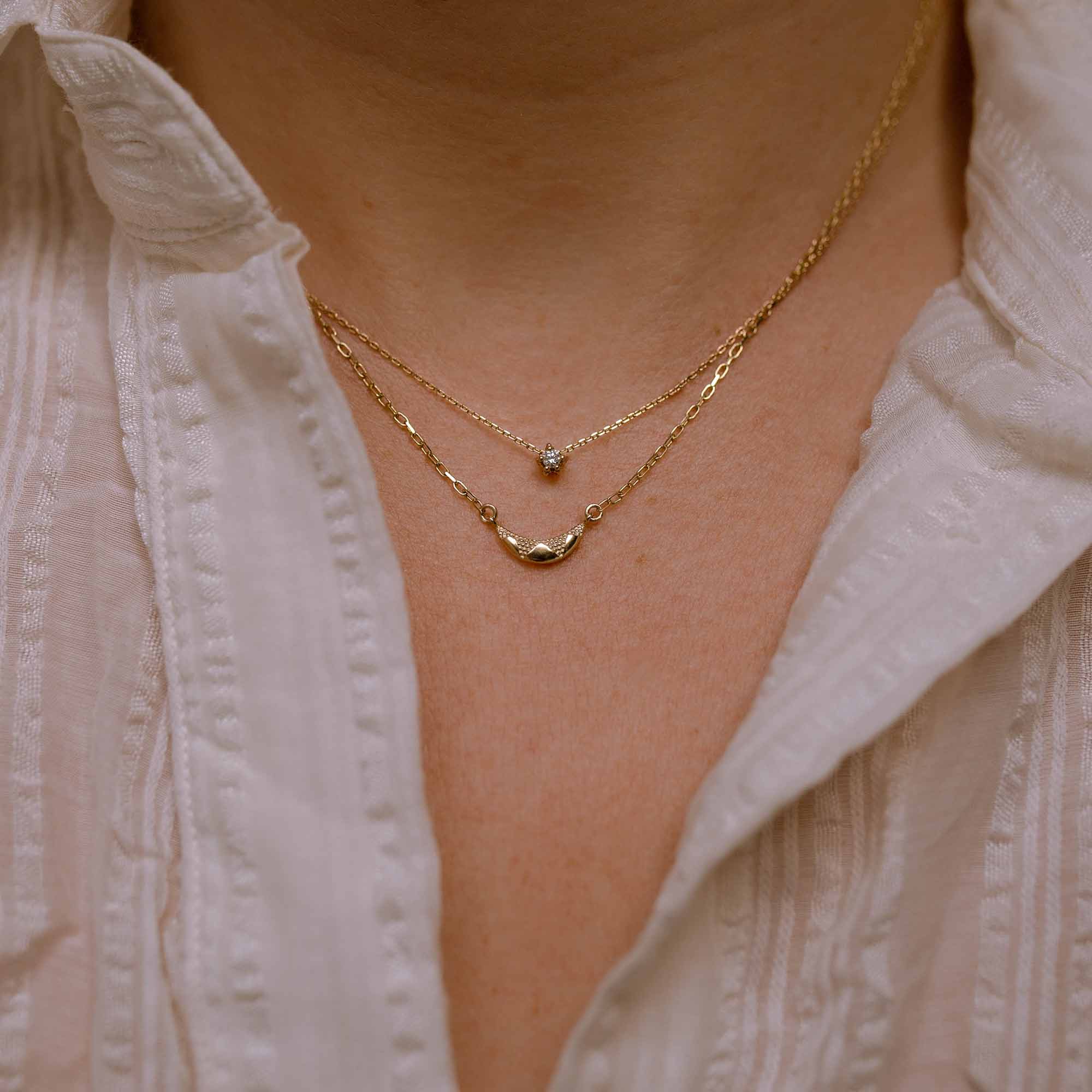 Diamond and moon gold necklaces worn together