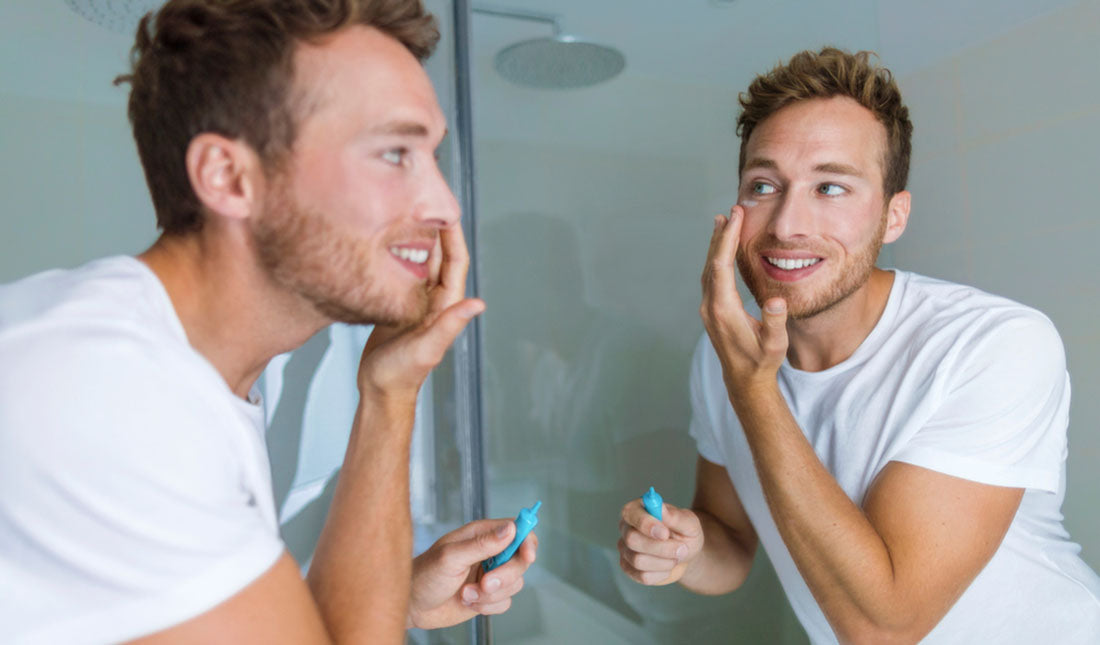 applying facial cream to cheek