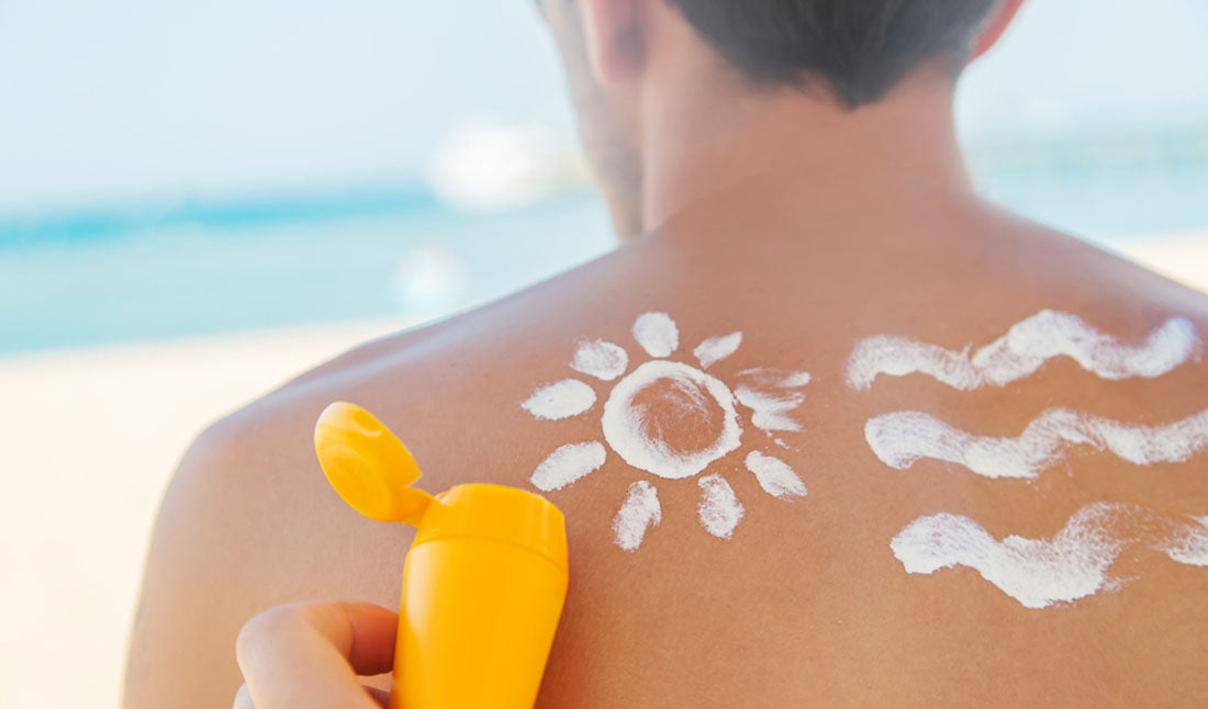 applying sunscreen to back