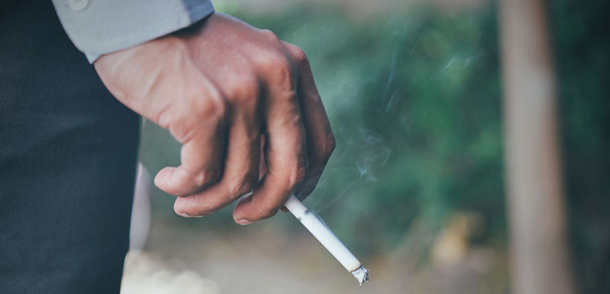 closeup of hand holding cigarette