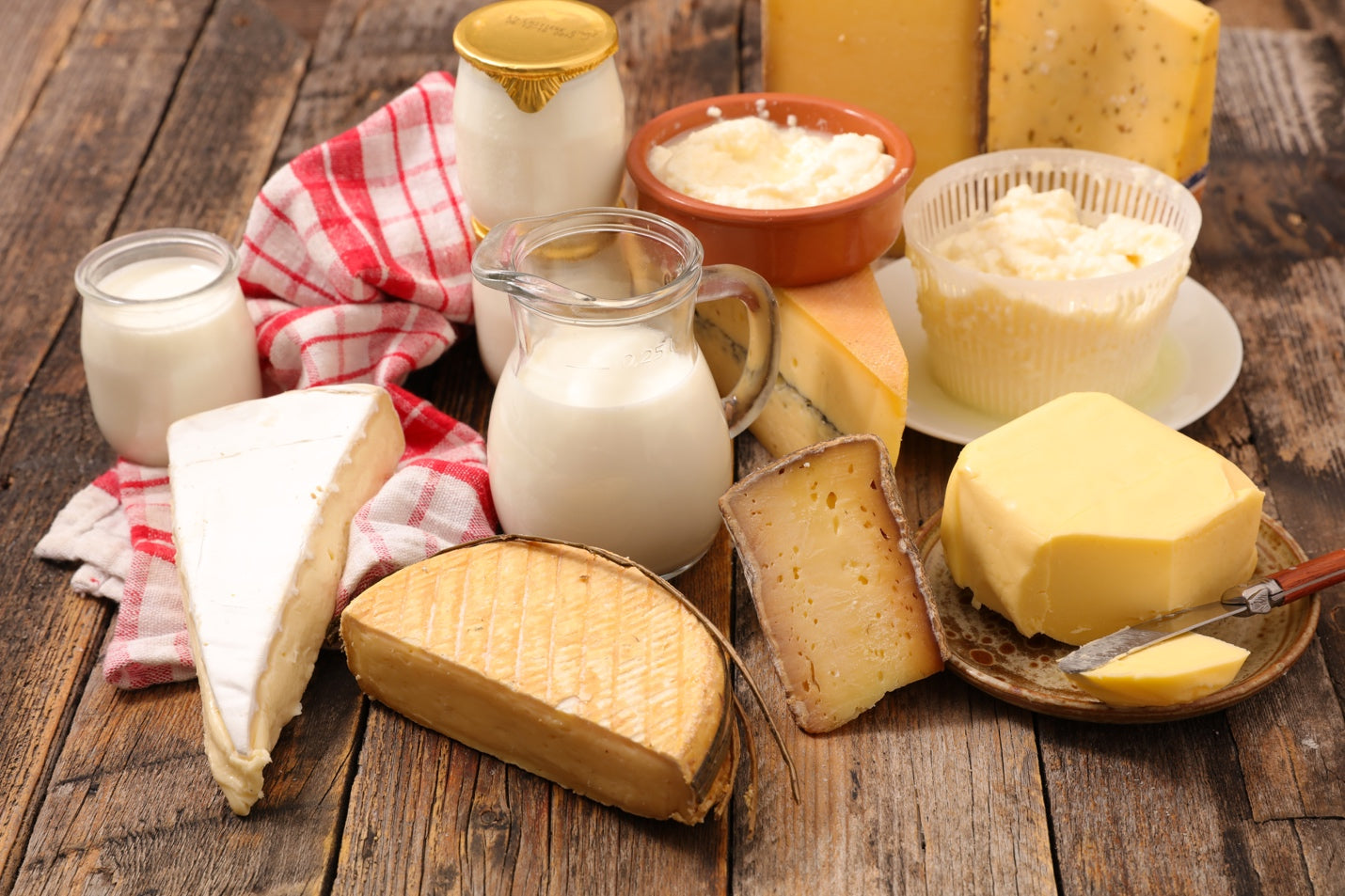 Different dairy products on a wood table