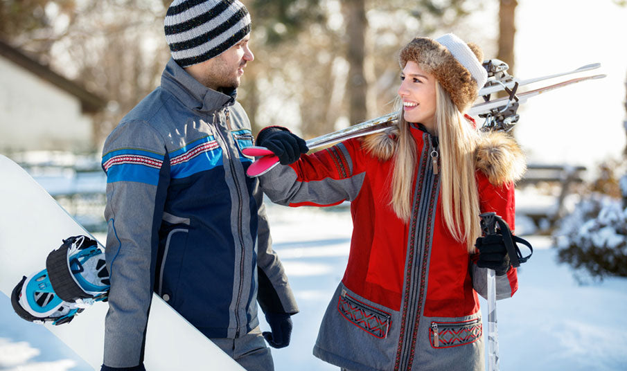 couple carrying ski equipment