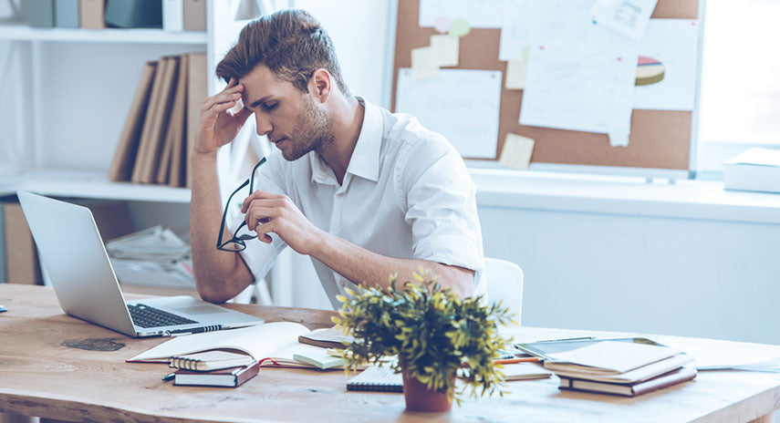 man exhausted at desk