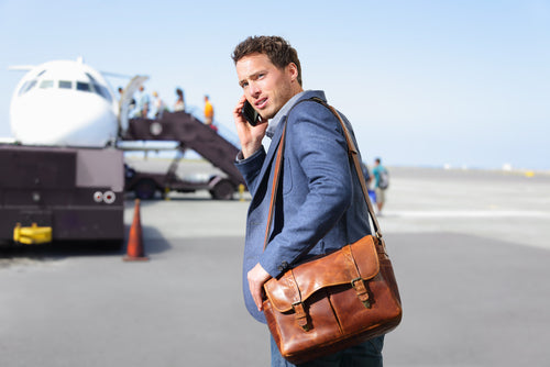 man taking call at airport