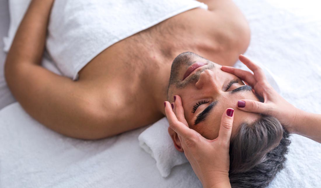 man receiving facial massage