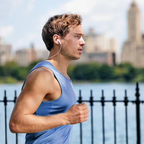 man running listening to headphones