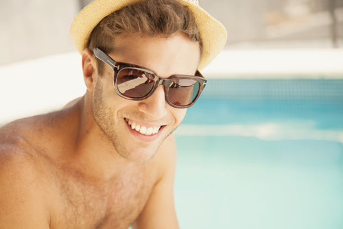 man wearing sunglasses by pool