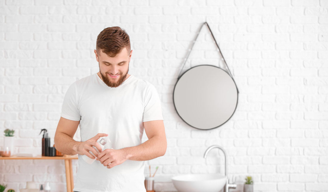 man using hand lotion